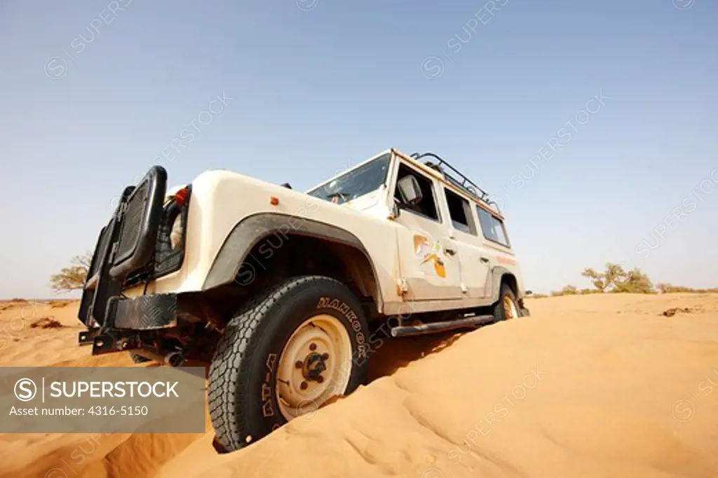 Digging out a Land Rover stuck in sand, Erg Chegaga, interior Sahara Desert, Morocco