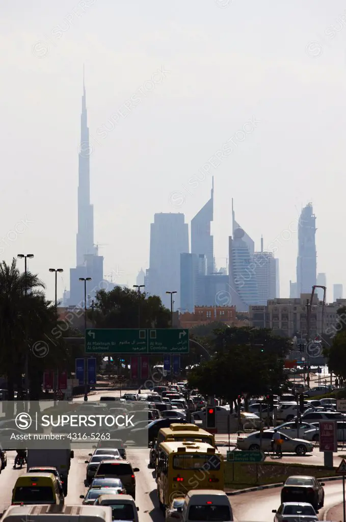 Traffic on the road with city skyline in the background, Burj Khalifa, Dubai, United Arab Emirates