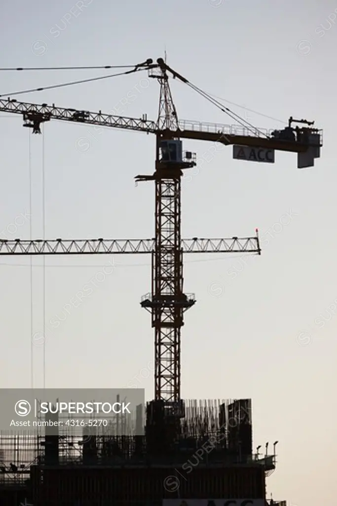 Massive construction crane atop high rise building, Dubai, United Arab Emirates