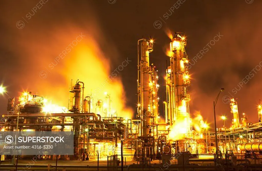 Night view of fluid catalytic cracking unit at a petroleum processing facility, Pasadena, Houston, Texas, USA