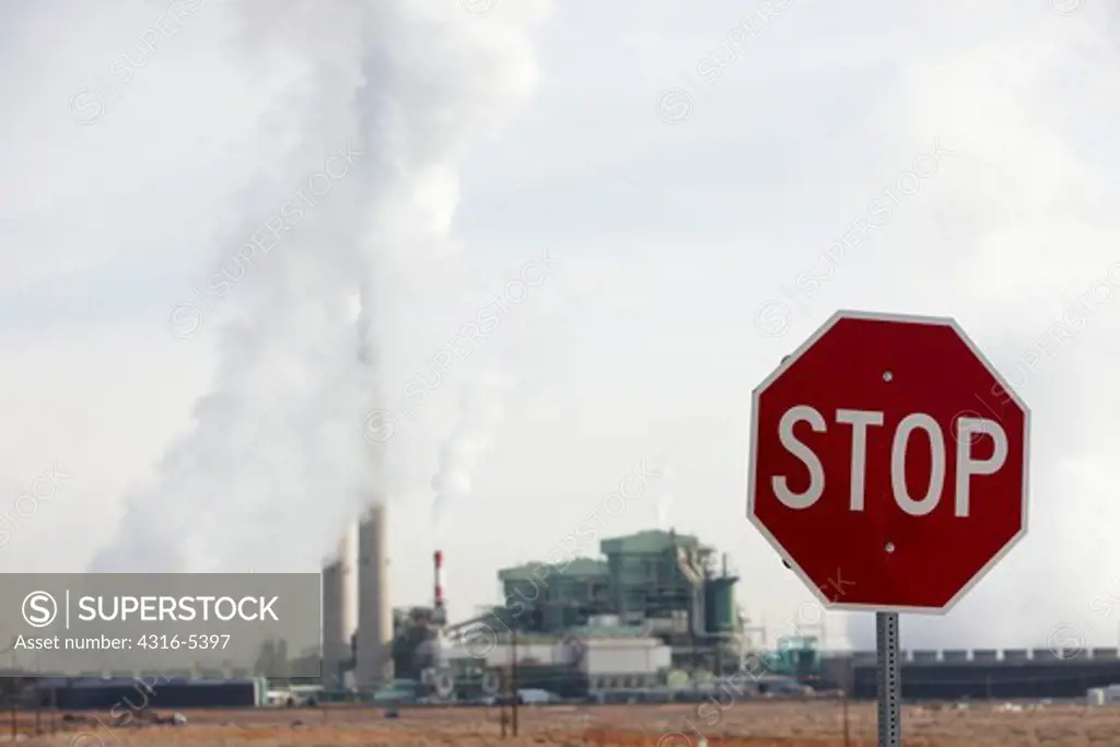 Stop sign with the Cholla Power Plant a large coal burning power plant in Joseph City, Arizona, USA