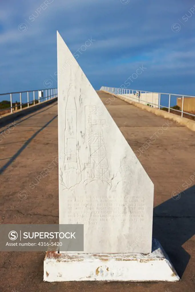 Granite memorial marker commemorating John Glenn's first orbit and Project Mercury located at the base of the concrete ramp leading to the launch pad at Cape Canaveral Air Force Station's Launch Complex 14, Cape Canaveral Air Force Station, Cape Canaveral, Florida, USA