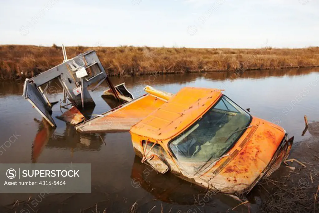 Car destroyed and partially submerged in swamp by a hurricane, Cameron, Louisiana, USA