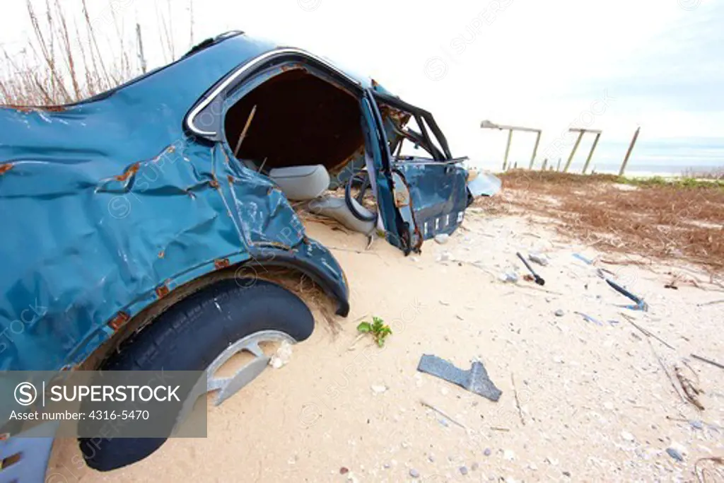 Remnants of car and house destroyed and buried by hurricane, Peveto Beach, Louisiana, USA