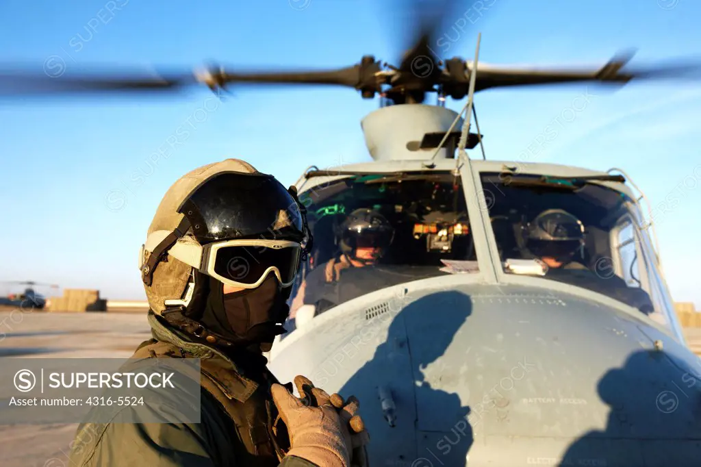 United States Marine Corps aviators and ground crew prepare to launch a UH-1Y Venom helicopter on a combat operation in the Helmand Province, Afghanistan