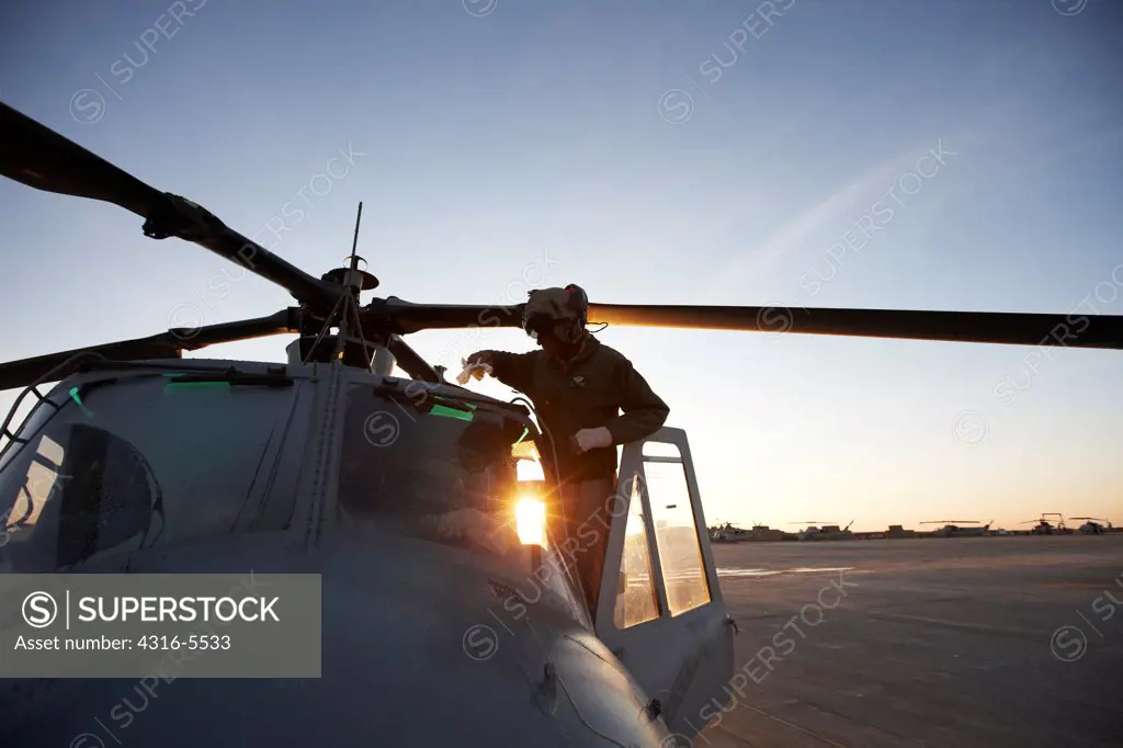 United States Marine Corps aviators and ground crew prepare to launch a UH-1Y Venom helicopter on a combat operation in the Helmand Province, Afghanistan
