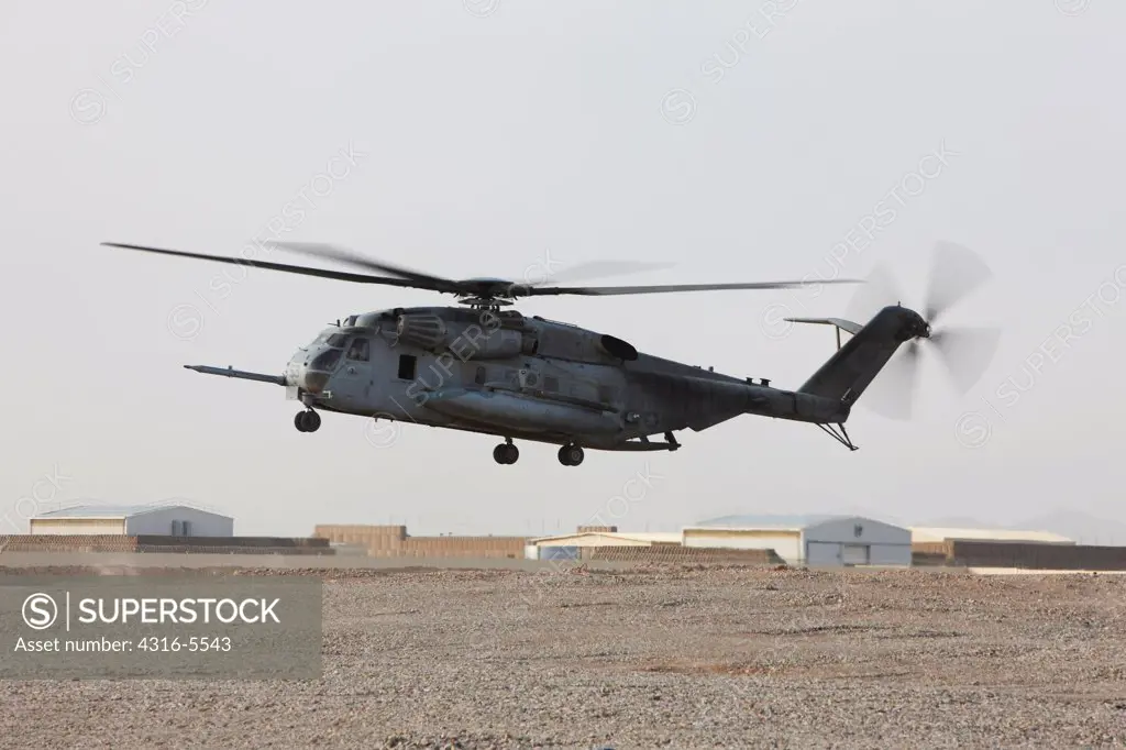 United States Marine Corps CH-53E Super Stallion hovers above a helicopter landing zone, Camp Bastion, Helmand Province, Afghanistan