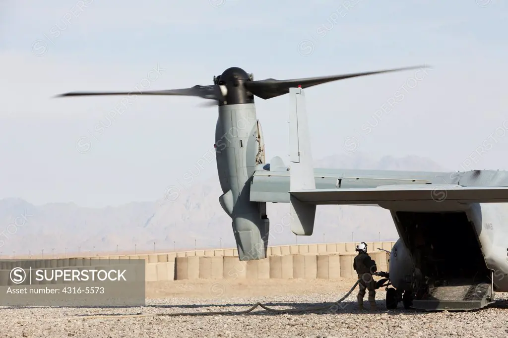 United States Marine refuels an MV-22 Osprey at a remote forward operating base in Afghanistan's Helmand Province