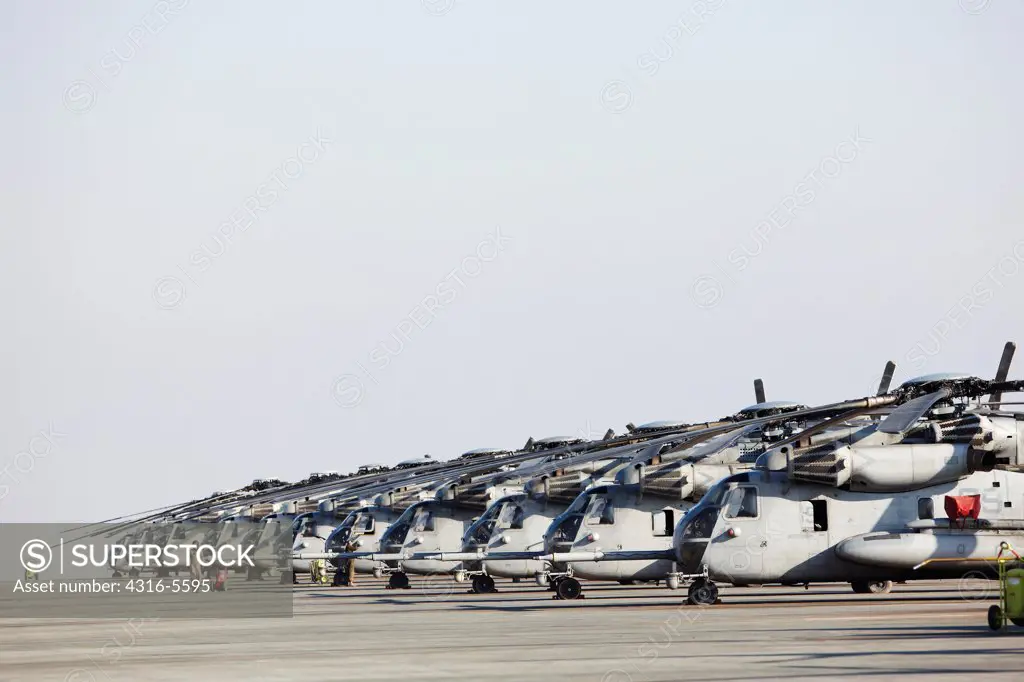View of nose sections and cockpits of line of United States Marine Corps CH-53E Super Stallion heavy lift helicopters, Camp Bastion, Helmand Province, Afghanistan