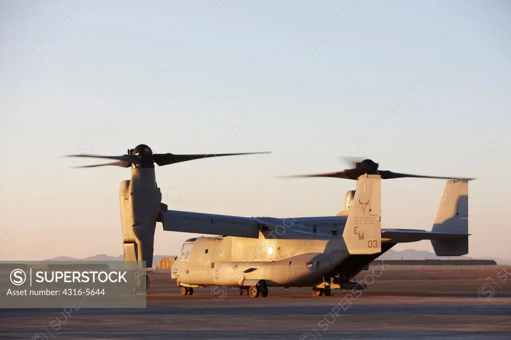 United States Marine Corps MV-22 Osprey, with proprotors spinning, prepares to depart on a mission from Camp Bastion, Helmand Province, Afghanistan