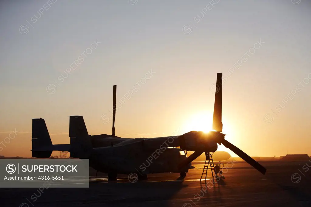 United States Marine Corps aircraft maintenance specialist working on an engine housed inside an engine nacelle of an MV-22 Osprey, Camp Bastion, Helmand Province, Afghanistan