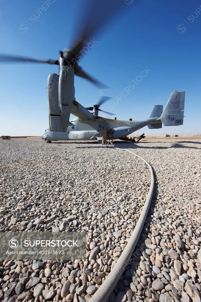 United States Marines refuel an MV-22 Osprey at a remote austere combat outpost in the Helmand Province, Afghanistan