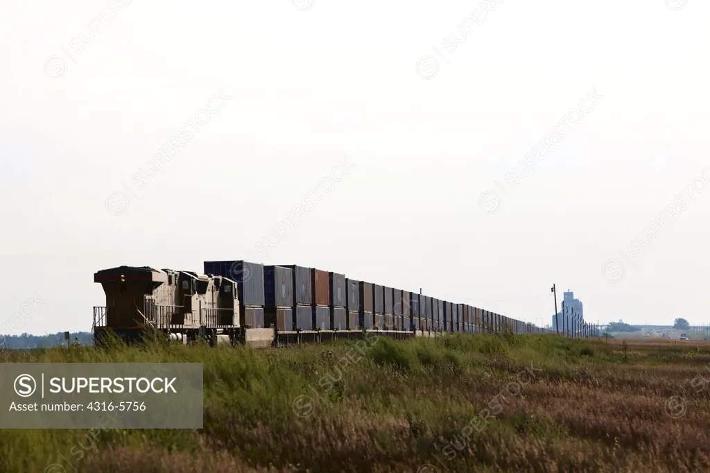 USA, Kansas, Freight Train, distant grain elevator