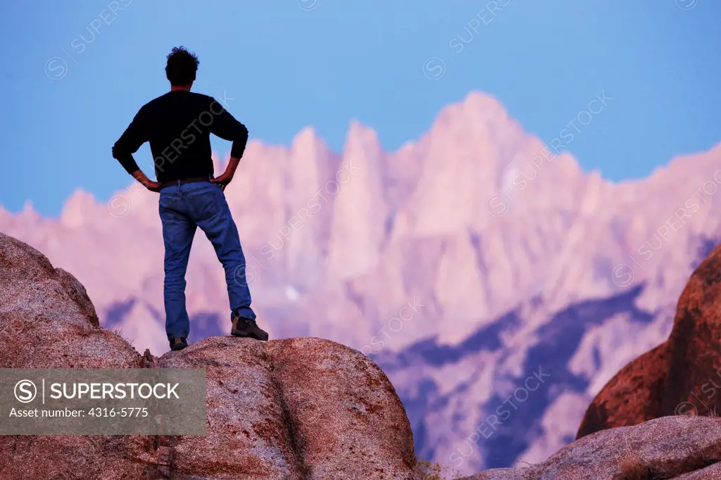 USA, California, Man gazing at Mount Whitney from Alabama Hills, near town of Lone Pine