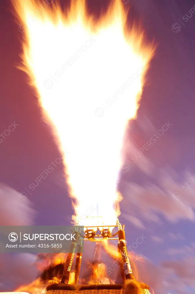 USA, New Mexico, Albuquerque, Aeronaut, or hot air balloon pilot testing propane burners prior to flight