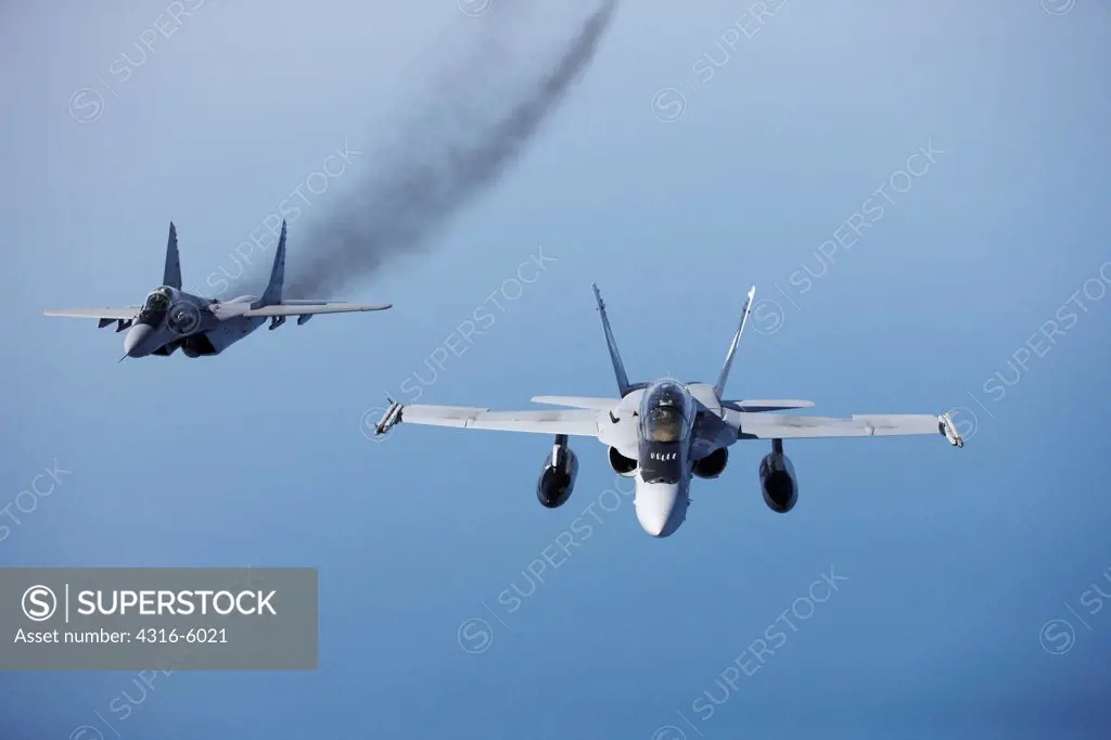 Royal Malaysian Air Force Mig-29 Fulcrum maneuvering into position with United States Marine Corps F/A-18D Hornet