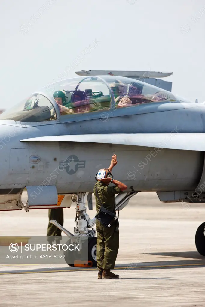 Malaysia, Kuantan Air Base, United States Marine Corps ground crew directing F/A-18D Hornet during international military training exercise