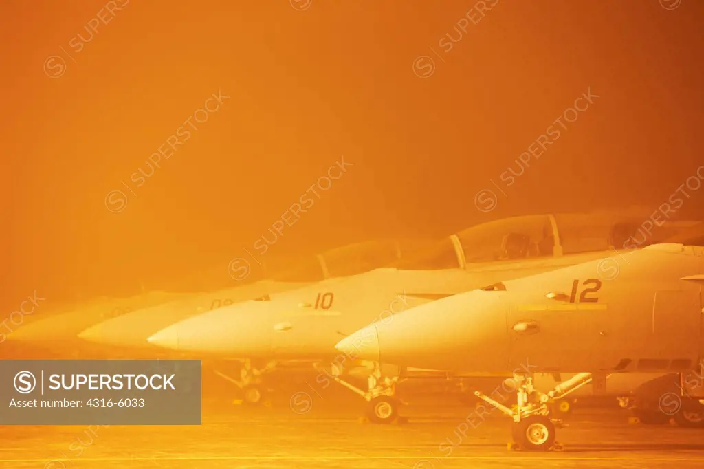 Malaysia, Kuantan Air Base, Line of United States Marine Corps F/A-18D Hornets in mist at flight lane