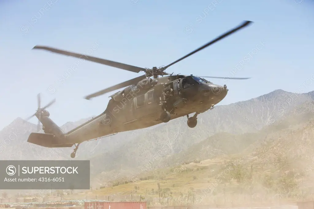Afghanistan, Kunar Province, Hindu Kush Mountains, United States Army UH-60 Blackhawk helicopter approaching landing strip at remote combat outpost