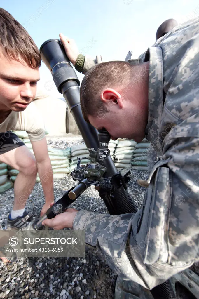 Afghanistan, Kunar Province, United States Army soldiers adjusting 81mm mortar tube