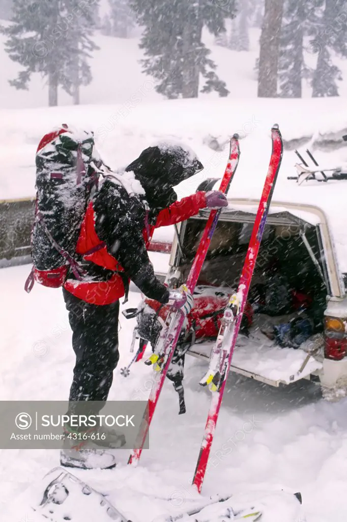 A Ski Mountaineer Prepares His Skis for a Stormy Ascent of Mount Shasta