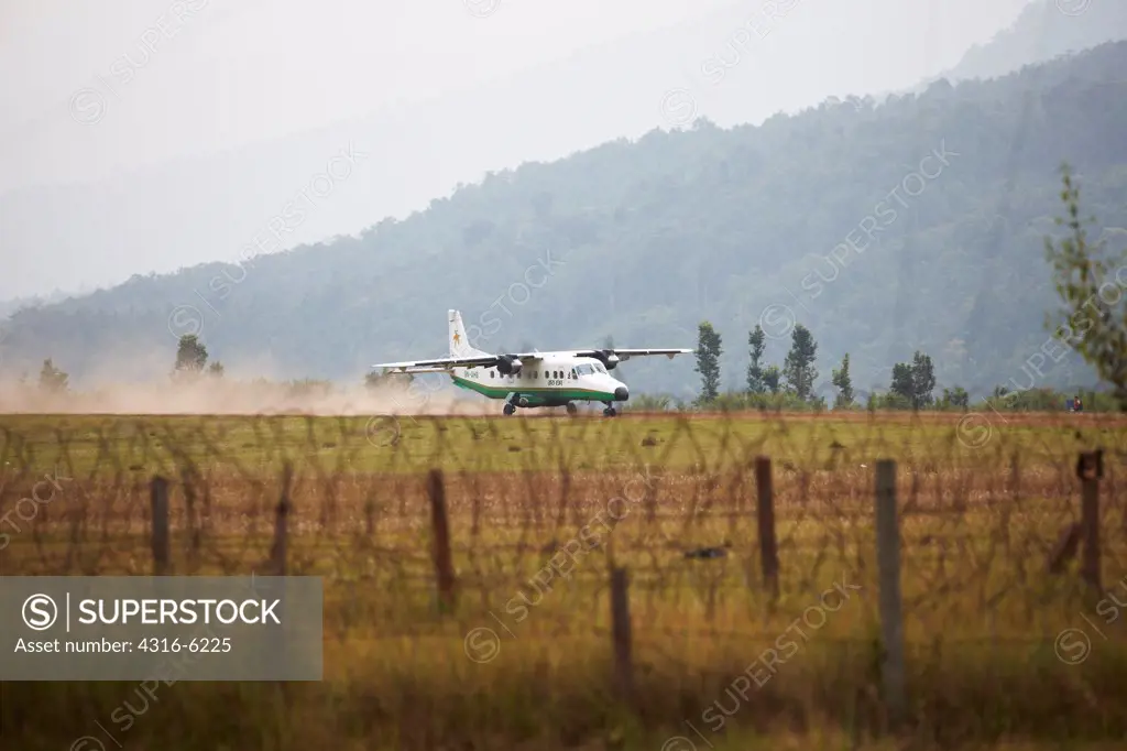 Nepal, Tumlingtar, Dornier Do 228, carrying passengers, landing on dirt runway