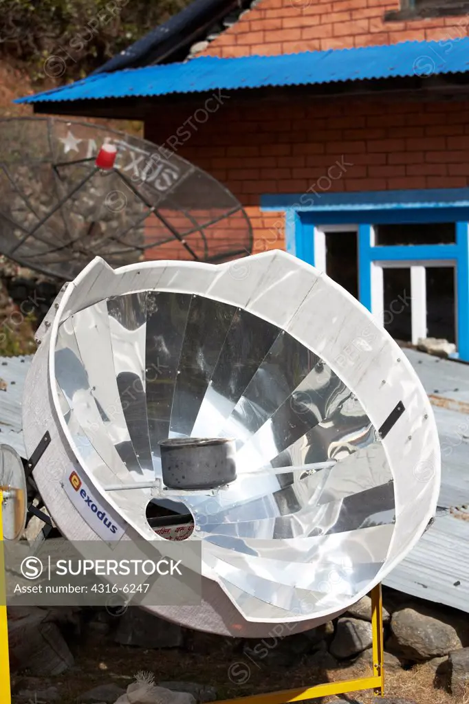 Nepal, Khumbu Region, Paraboloid mirror solar water heater with pot