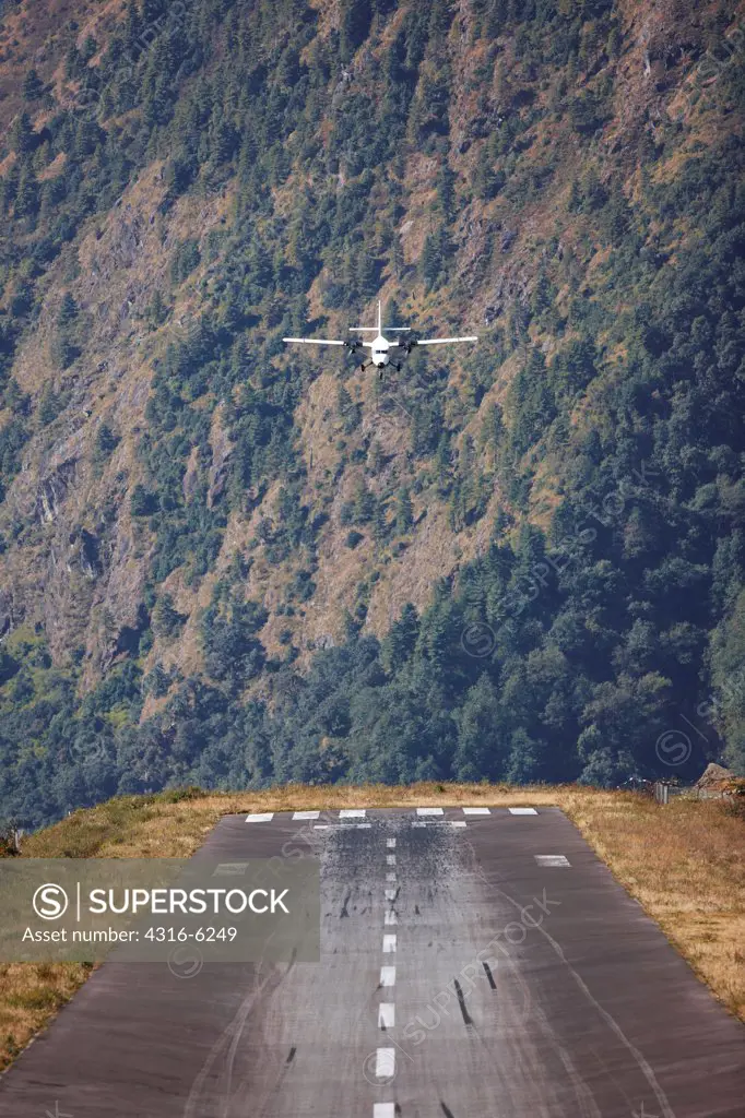 Nepal, Khumbu Region, Lukla, Tenzing-Hillary Airport, twin-turboprop aircraft taking off, rear view
