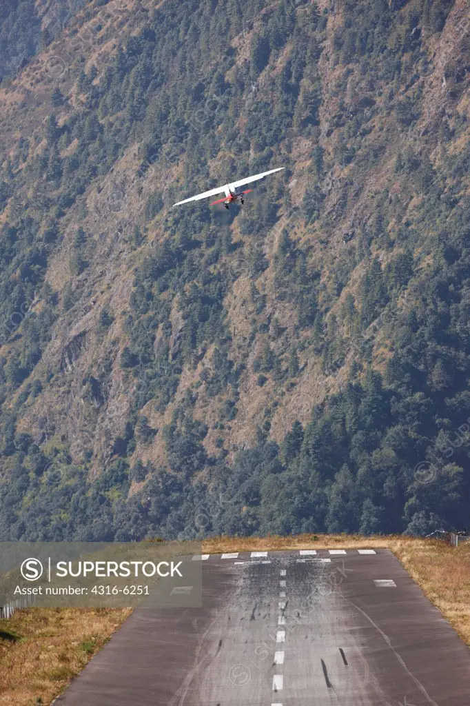 Nepal, Khumbu Region, Lukla, Tenzing-Hillary Airport, twin-turboprop aircraft taking off, rear view