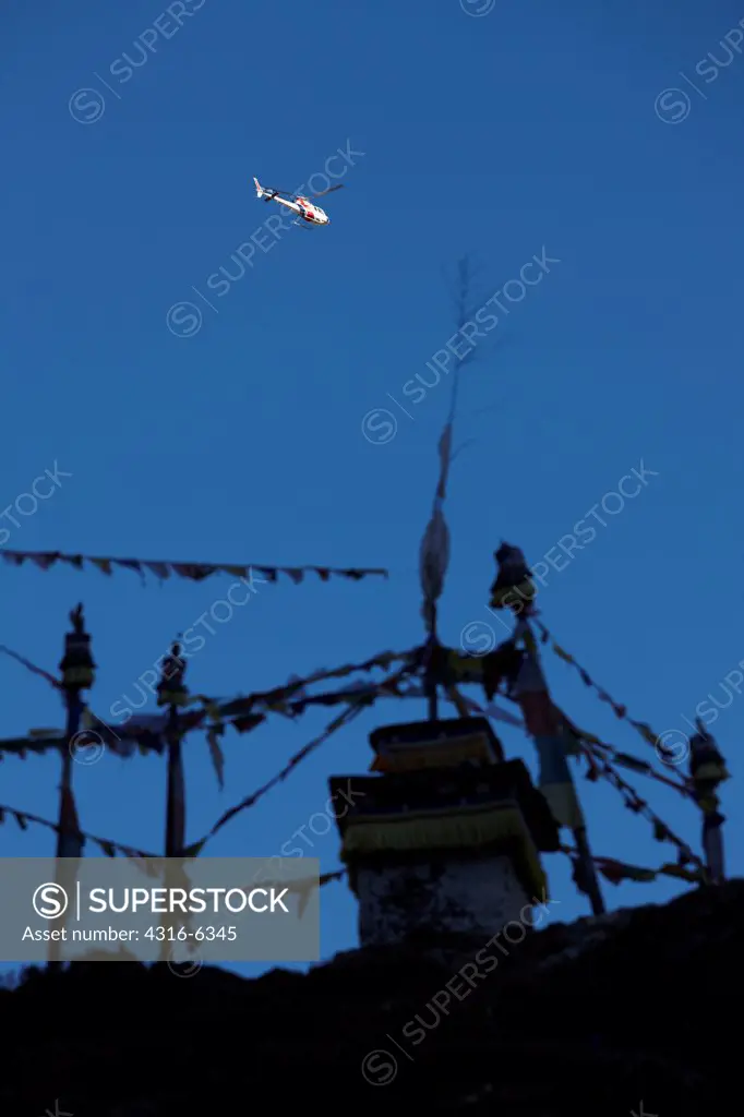Nepal, Himalaya, Solukhumbu District, Khumbu, Pangboche Village, helicopter above stupa