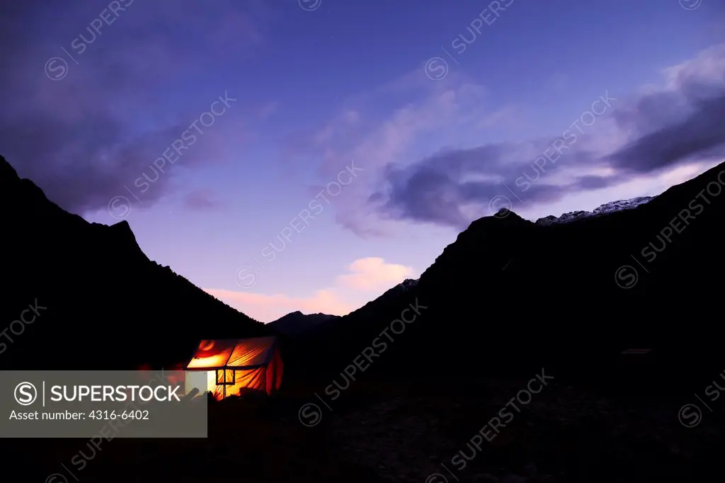 Nepal, Himalaya, Makalu-Barun National Park, Barun Valley, Riphuk Kharka, illuminated tent in evening