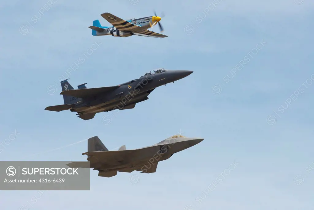 United States Air Force Legacy Flight including a P-51 Mustang and F-15E Strike Eagle and a F-22 Raptor during an airshow, Mather, California, USA