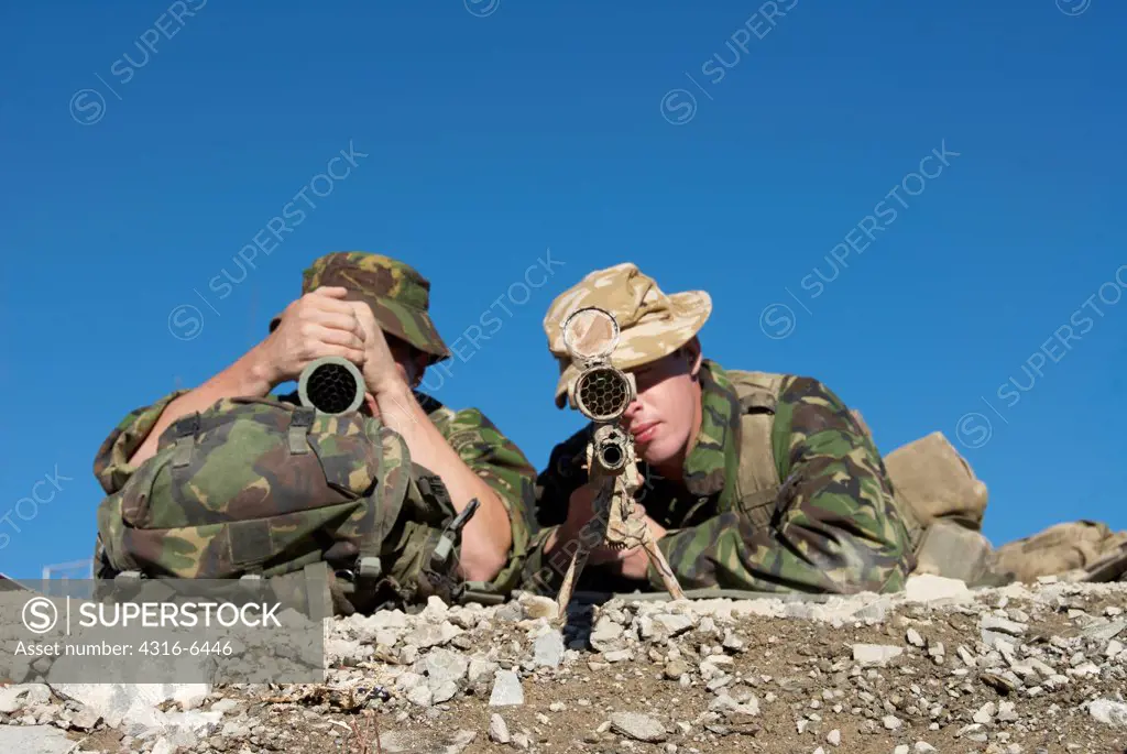 British Royal Marine aiming a sniper rifle during mountain sniper training, Hawthorne, Nevada, USA