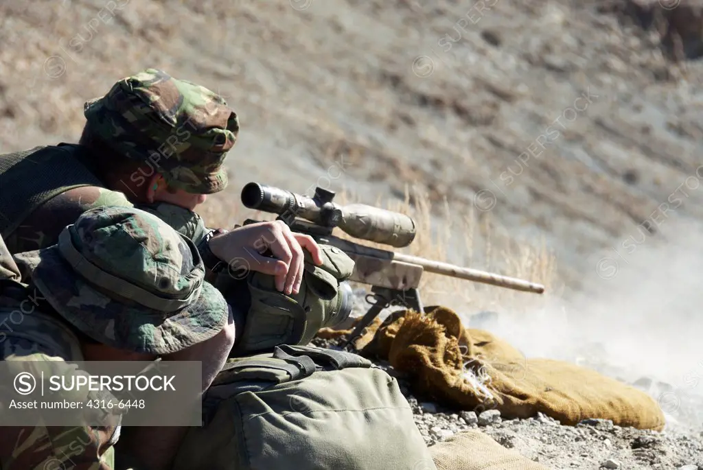 British Royal Marine firing a sniper rifle during mountain sniper training, Hawthorne, Nevada, USA