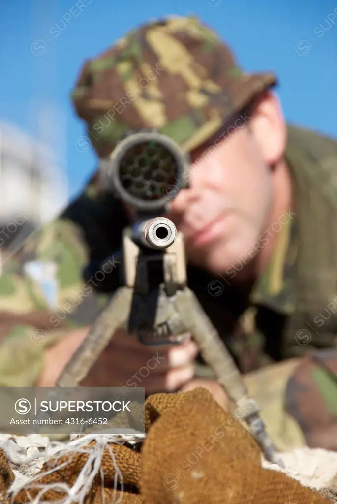 British Royal Marine aiming a sniper rifle during mountain sniper training, Hawthorne, Nevada, USA