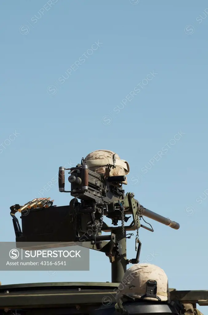 Kevlar helmet rests atop an M2 .50 caliber machine gun