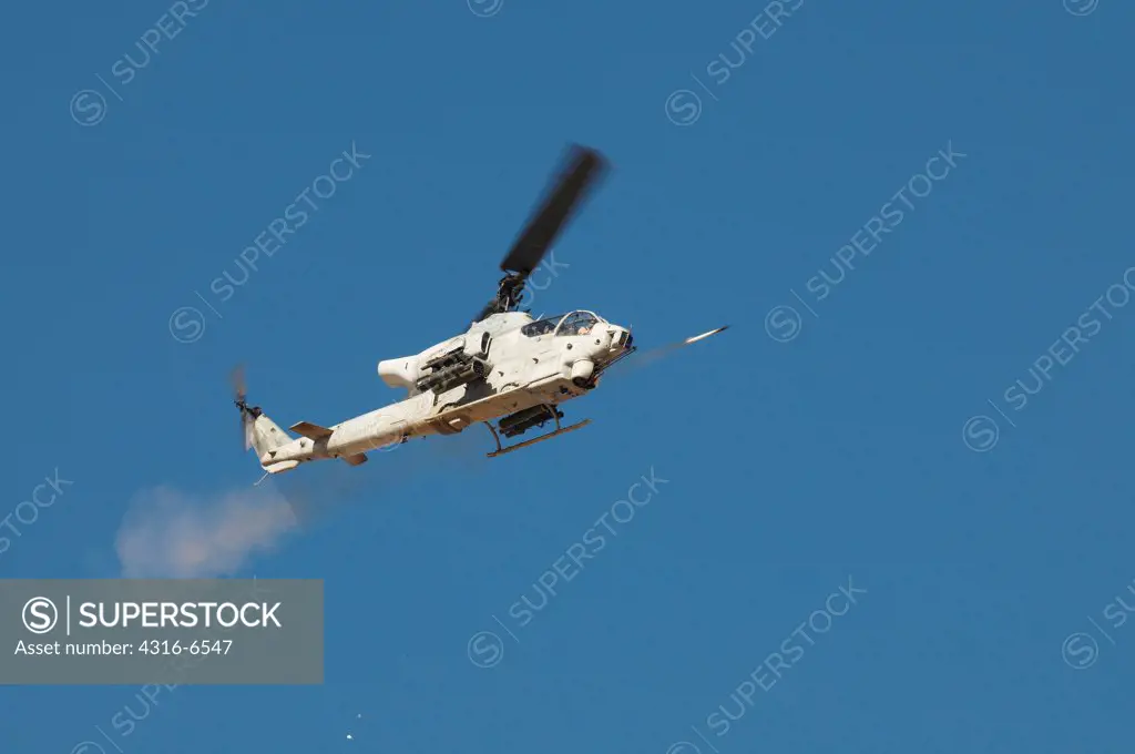 US Marine Corps AH-1W SuperCobra firing a Hydra 70 Rocket