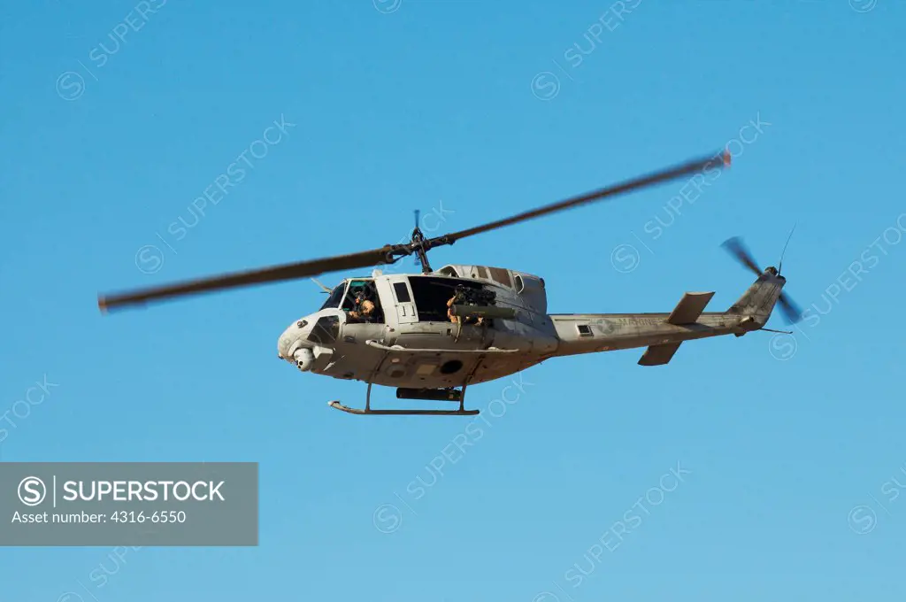 US Marine Corps UH-1N Iroquois Utility Helicopter fitted with rockets and machine guns for an attack mission during close air support training at Yodaville, Barry M. Goldwater Air Force Range, Arizona, USA