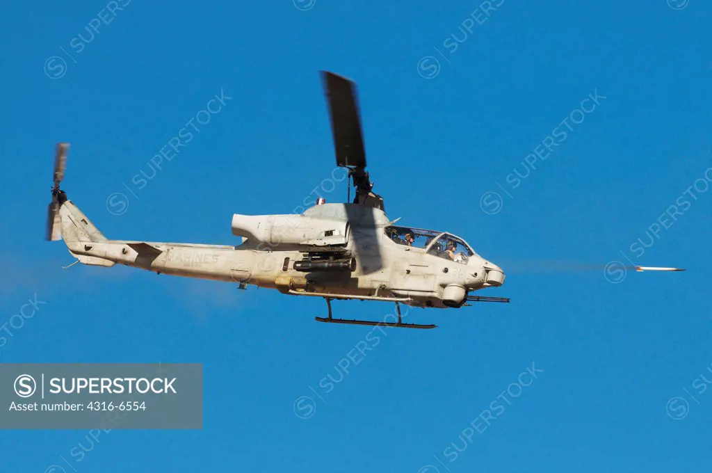 US Marine Corps AH-1W SuperCobra firing a Hydra 70 Rocket