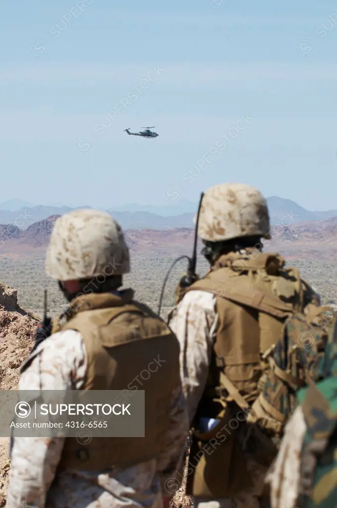 US Marines on the ground directing a Marine Corps AH-1W SuperCobra during live fire close air support training, Chocolate Mountain Aerial Gunnery Range, California, USA