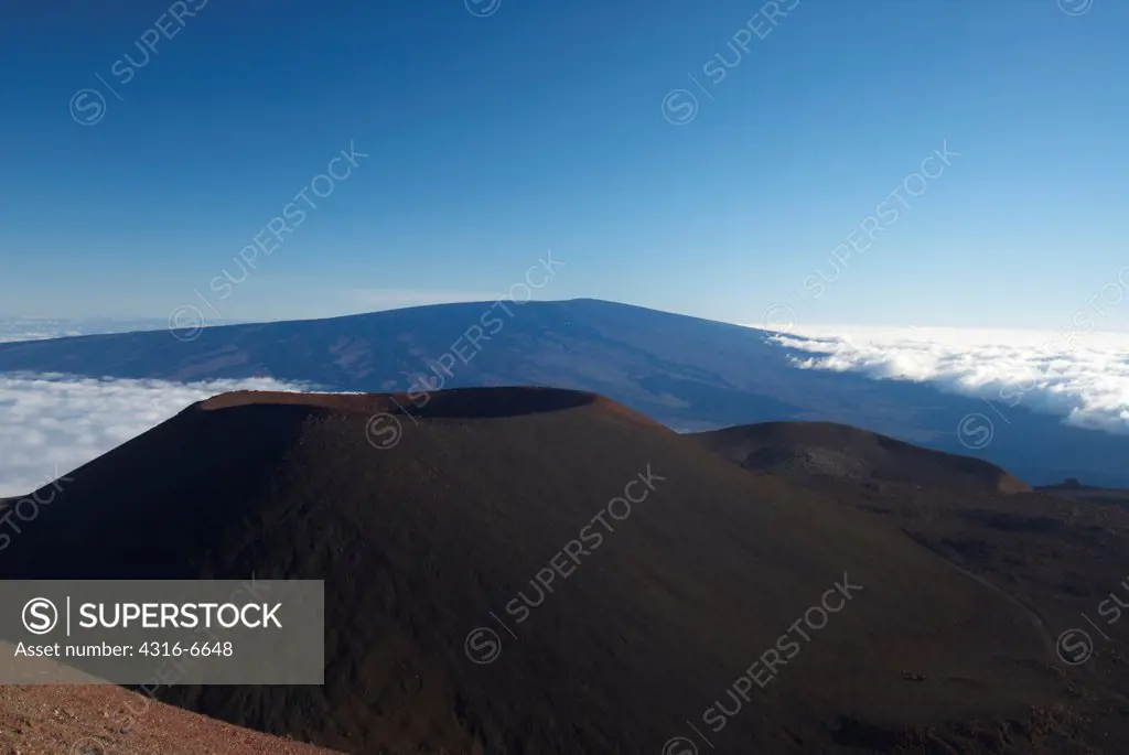 High angle view of Cinder Cones and distant Mauna Loa volcano from high on the slopes of Mauna Kea, Hawaii County, Hawaii, USA