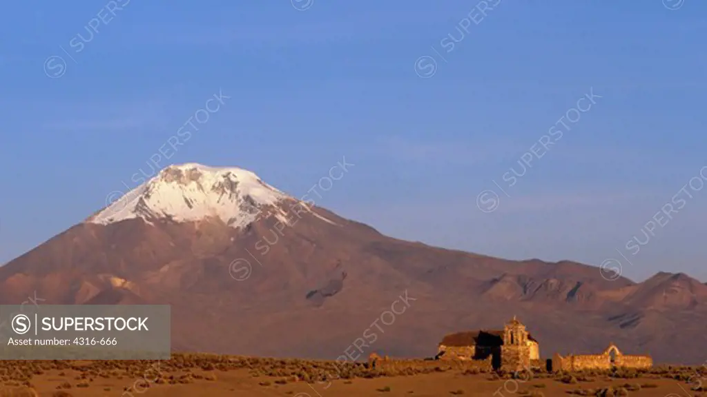 Church Dwarfed by Andean Volcano