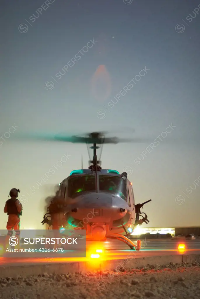 US Marine Corps aviators prepare to launch a Marine Corps UH-1N Iroquois at night from Al Asad Air Base, Al Anbar Province, Iraq