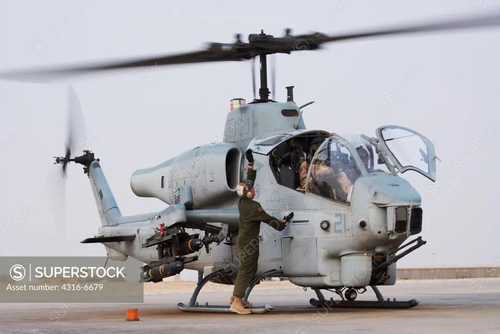 US Marine Corps aviator prepares to launch a Marine Corps AH-1W SuperCobra attack helicopter from Al Asad Air Base, Al Anbar Province, Iraq