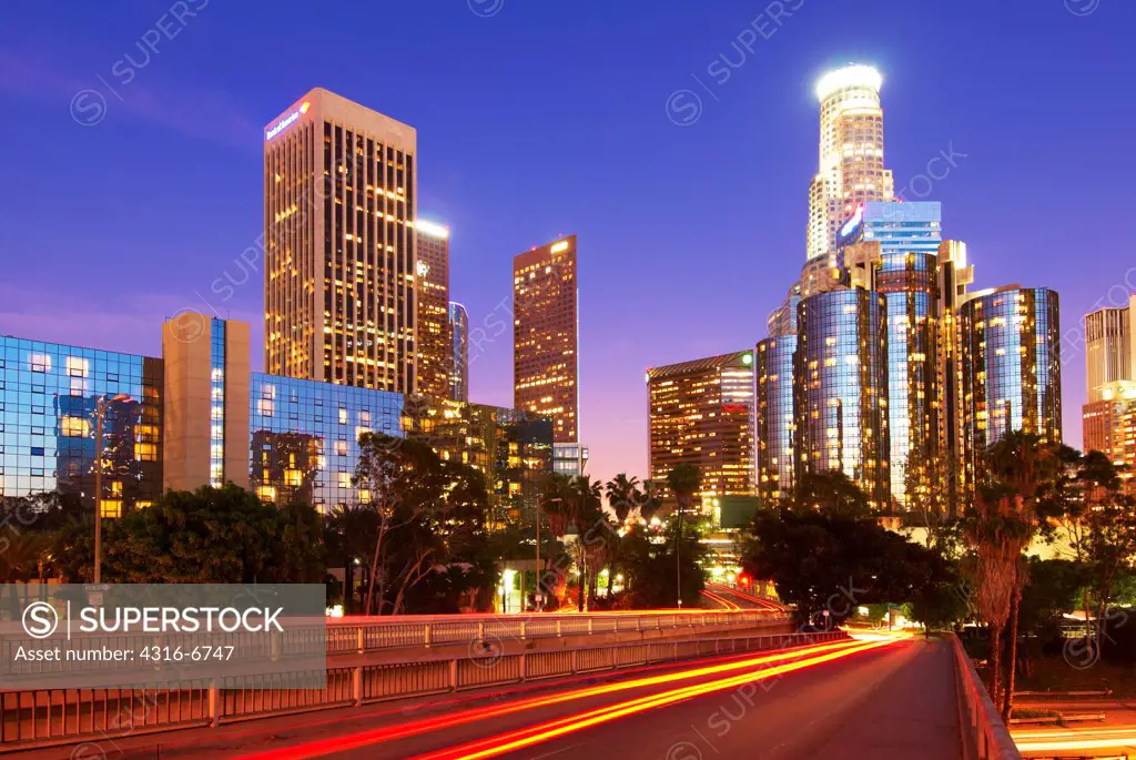 Streaks of lights of night traffic with city skyline, California State Route 110, Los Angeles, California, USA