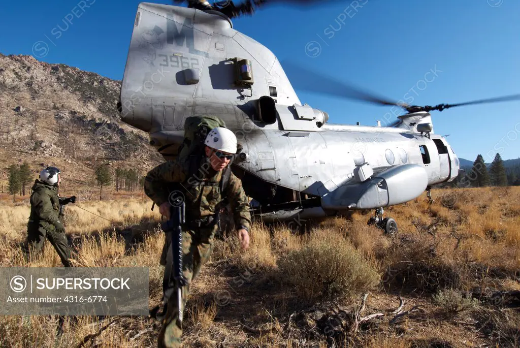 US Marine Corps CH-46 Sea Knight lands at a high altitude and unloads US Marines for mountain warfare training at Marine Corps Mountain Warfare Training Center, Bridgeport, California, USA