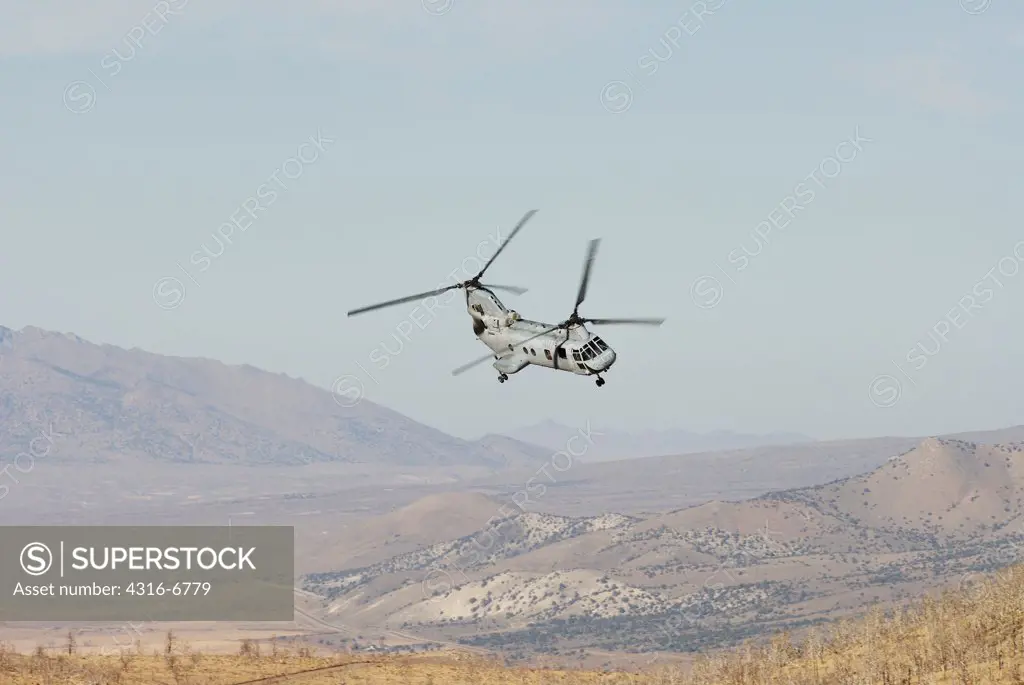 US Marine Corps CH-46 Sea Knight lands at a high altitude unimproved landing zone and unloads US Marines for mountain warfare training at the Marine Corps Mountain Warfare Training Center, Bridgeport, California, USA