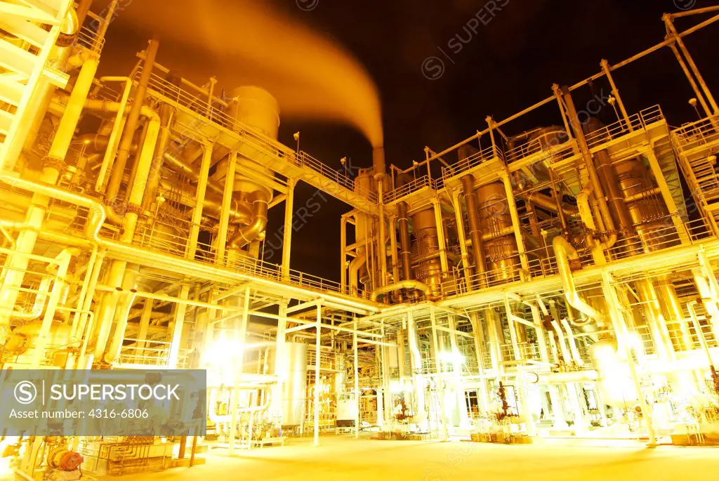 Large tomato processing factory at night, Central Valley, California, USA