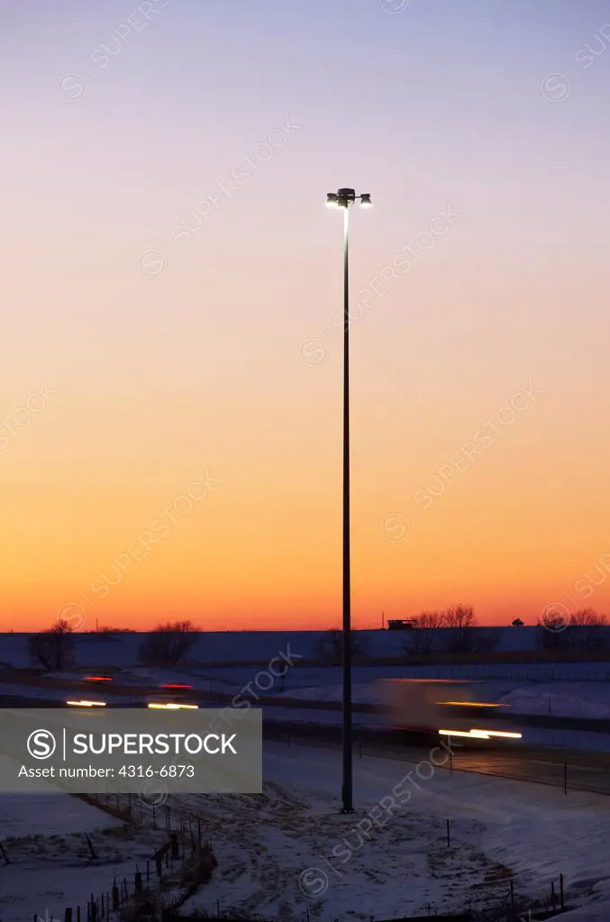 USA, Kansas, Cars at dusk streaking down interstate 70