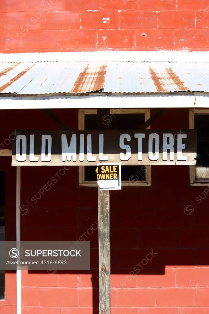 USA, Kansas, Abandoned mill store, broken for sale sign